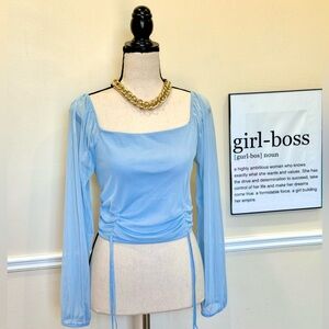 Light blue mesh top with cinched waist.
